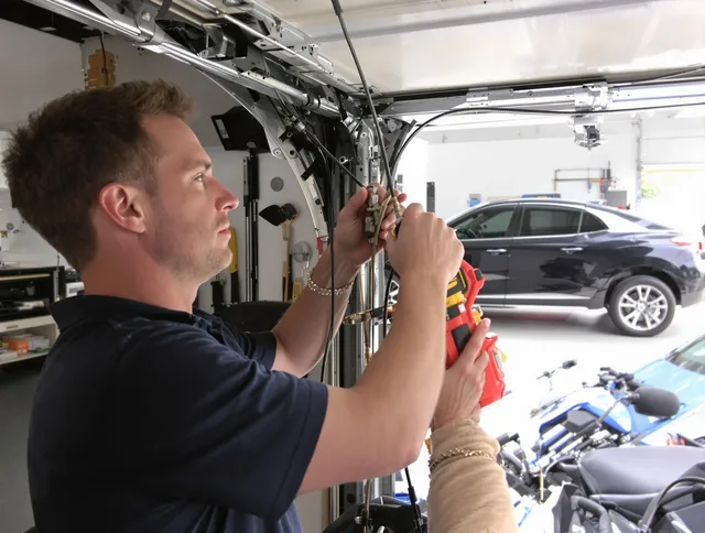 Millbury Garage Door Repair safety certified technician performing cable replacement in Millbury
